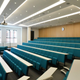 This higher education teaching space is fitted with fixed lecture theatre seating which incorporates rows of fixed desks. These offer ample space for students to make notes, refer to textbooks or use laptops or other tech.